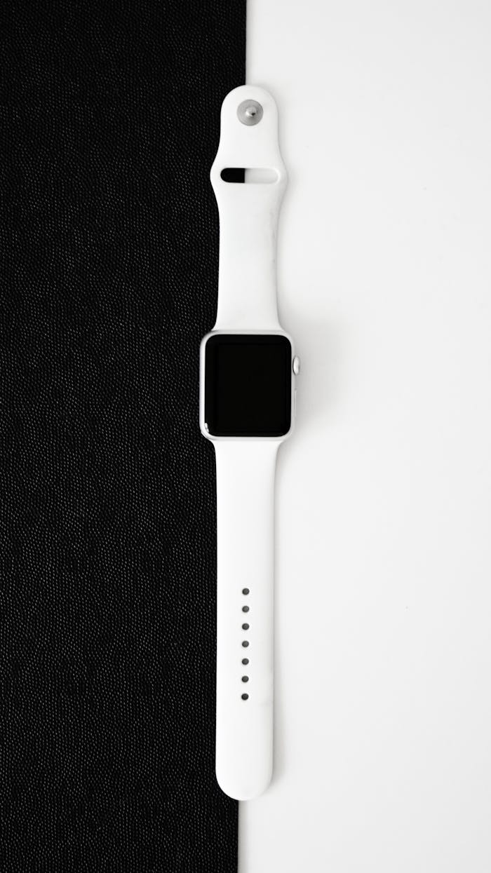 A stylish white smartwatch displayed on a clean black and white background.